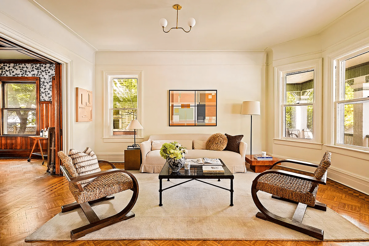 parlor with wood floor, windows looking out to the porch