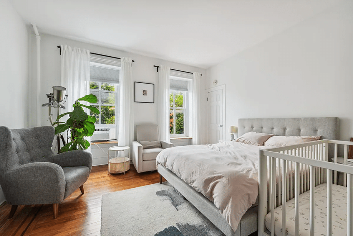 bedroom with two windows, wood floor