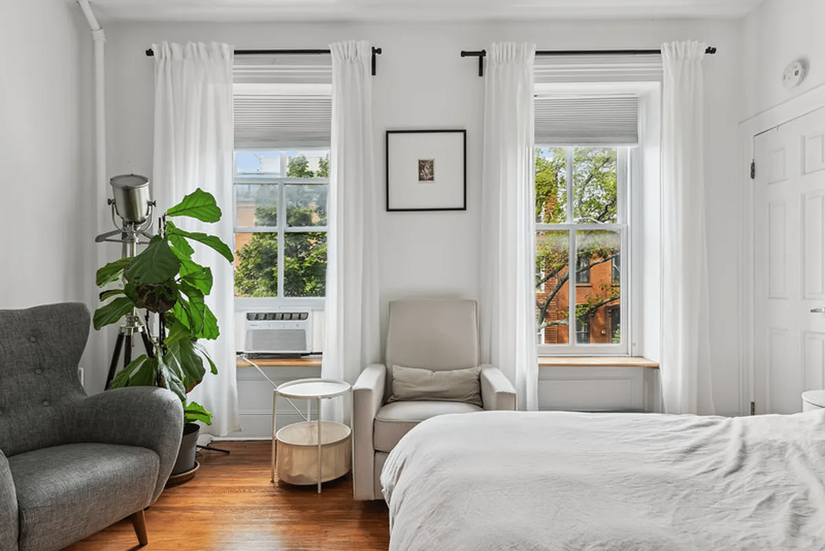 bedroom with two windows, wood floor