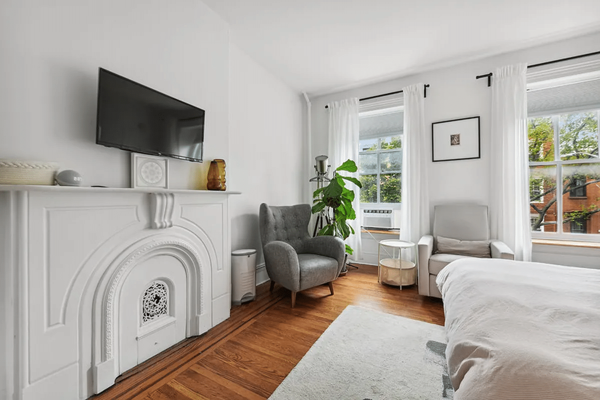 bedroom with two windows, wood floor