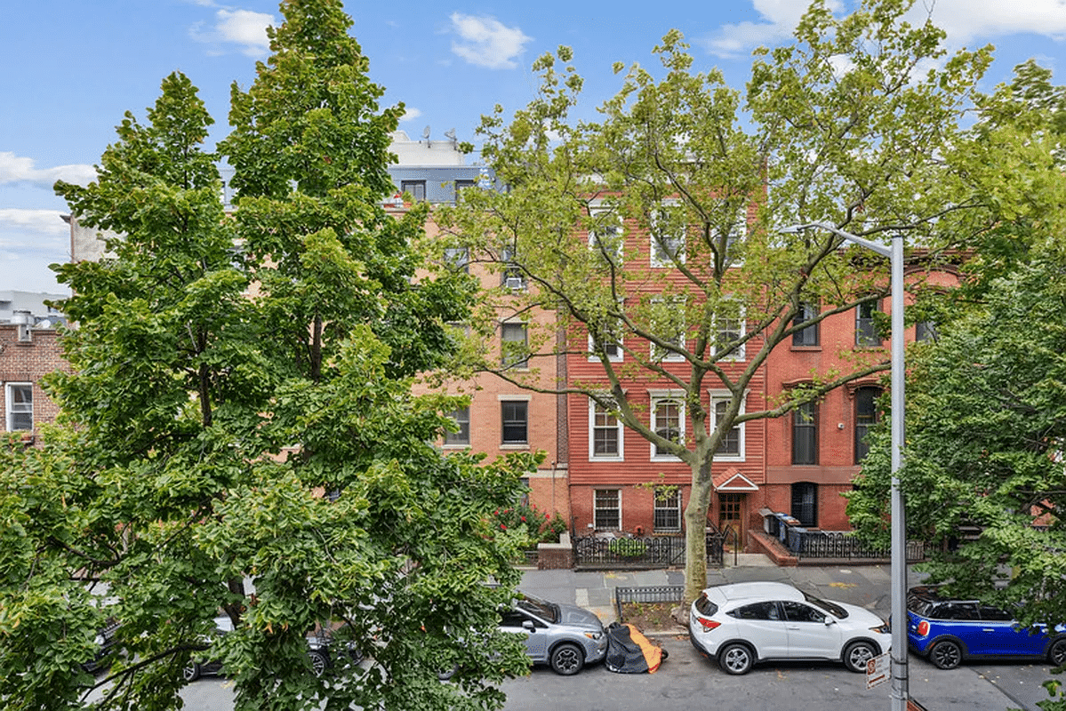 view from windows of unit to trees and buildings across the street