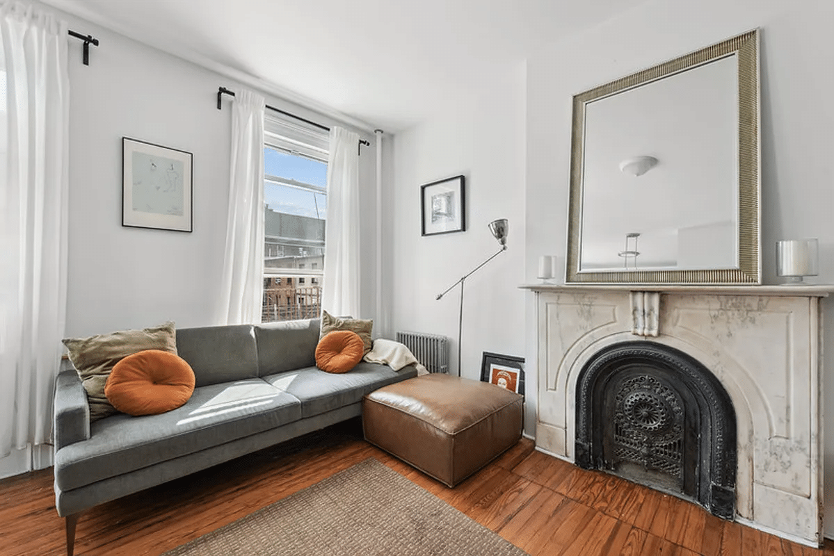 living room with marble mantel, wood floor