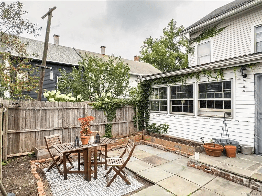 rear yard with raised beds, some unfinished paving