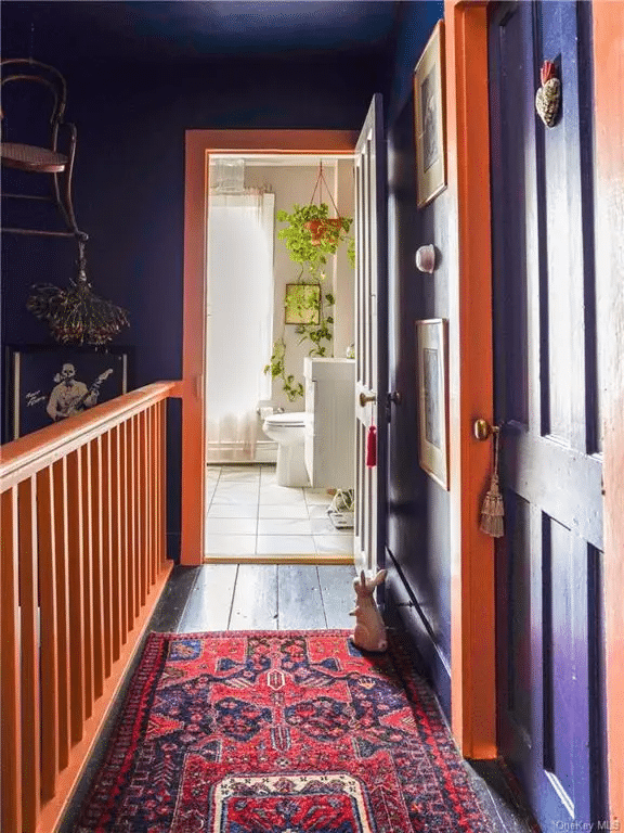 upstairs hallway with purple walls and orange trim