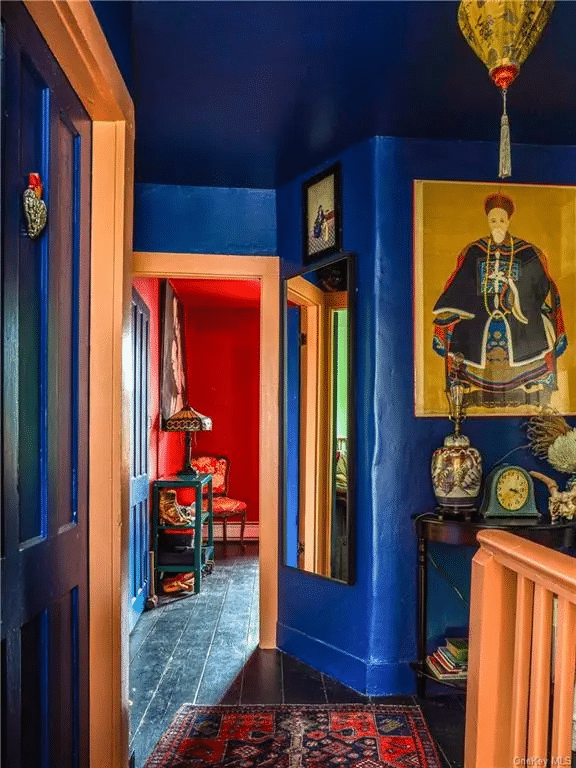 hallway with blue walls and orange trim