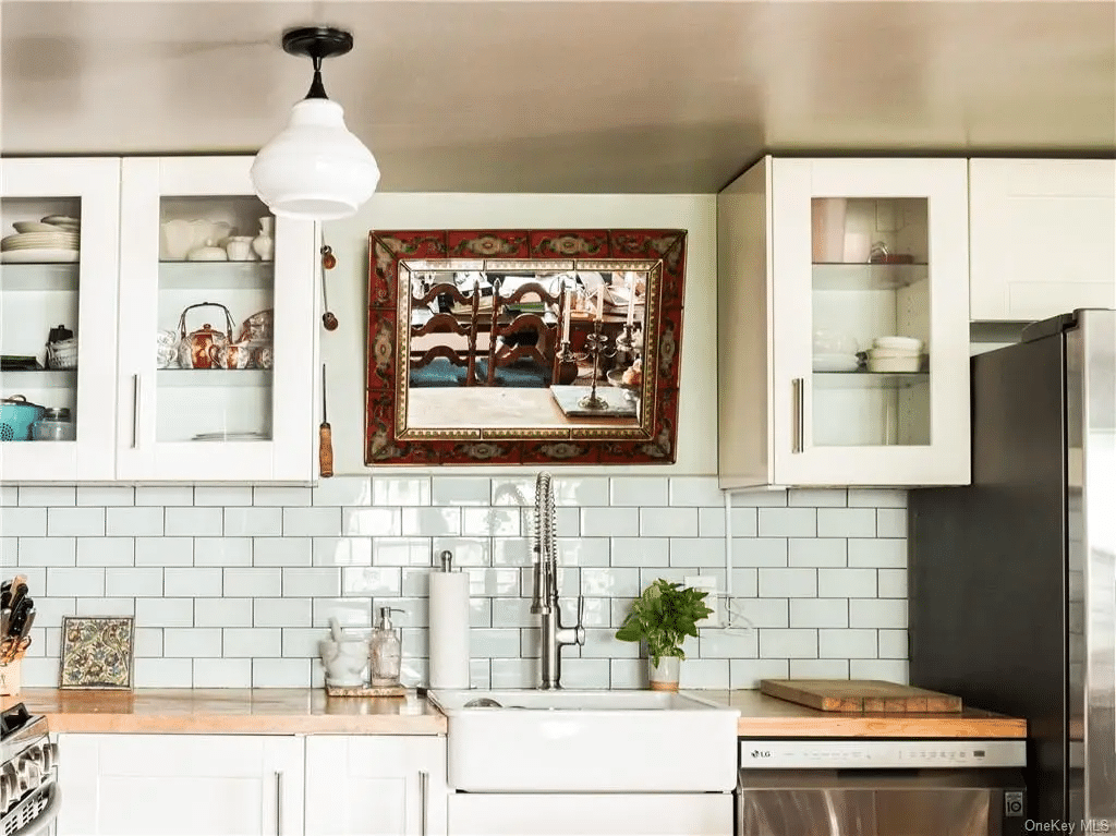 kitchen with white cabinets, white subway tile