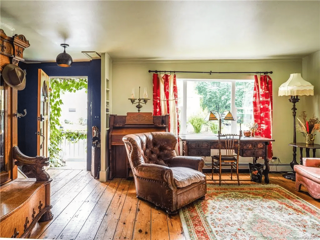 living room with wide planked floorboards, view to front door