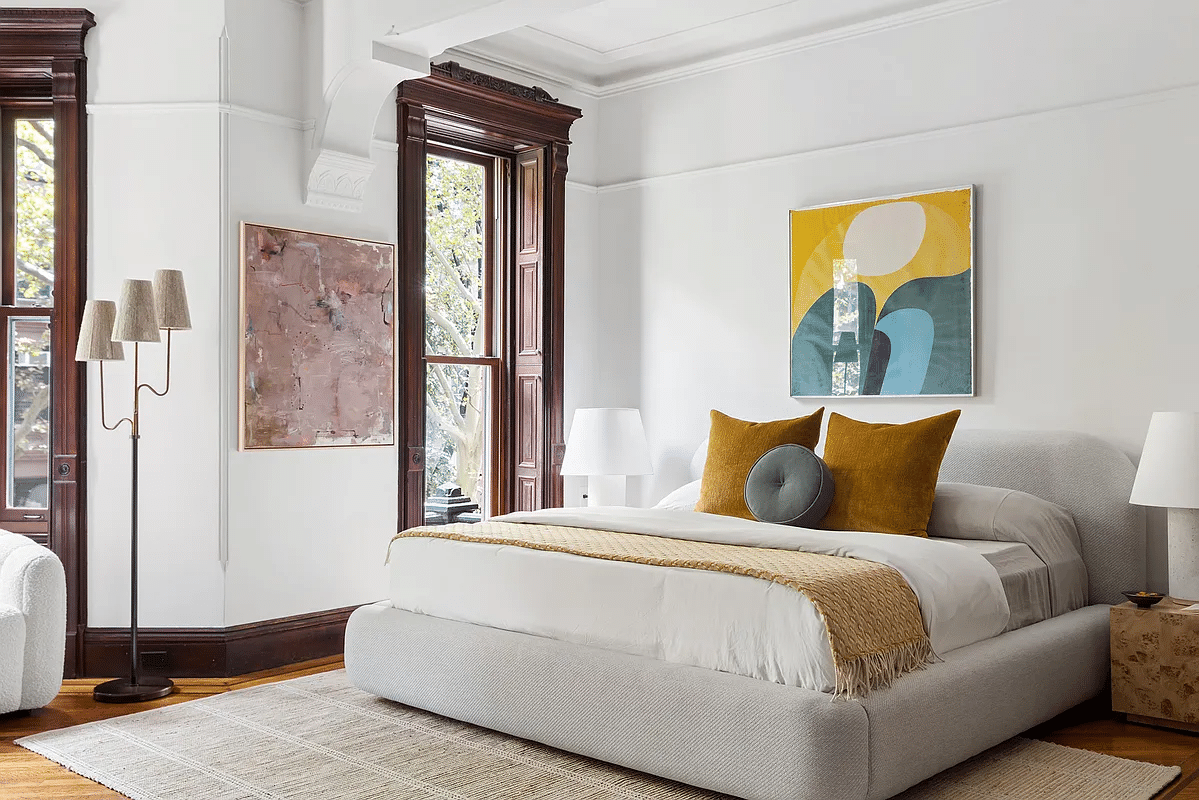 bedroom with wood moldings, wood floor, picture rail