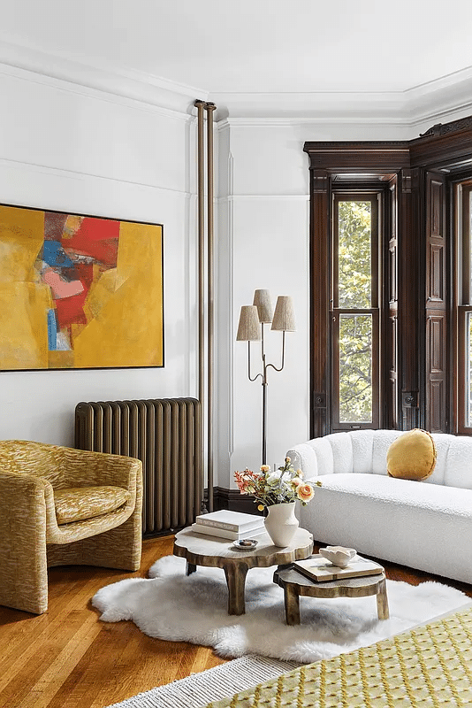 seating area in a bedroom with interior shutters in a bay window