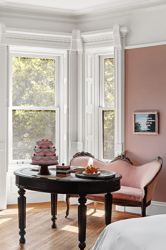 bedroom with white trim, mauve walls, picture rail