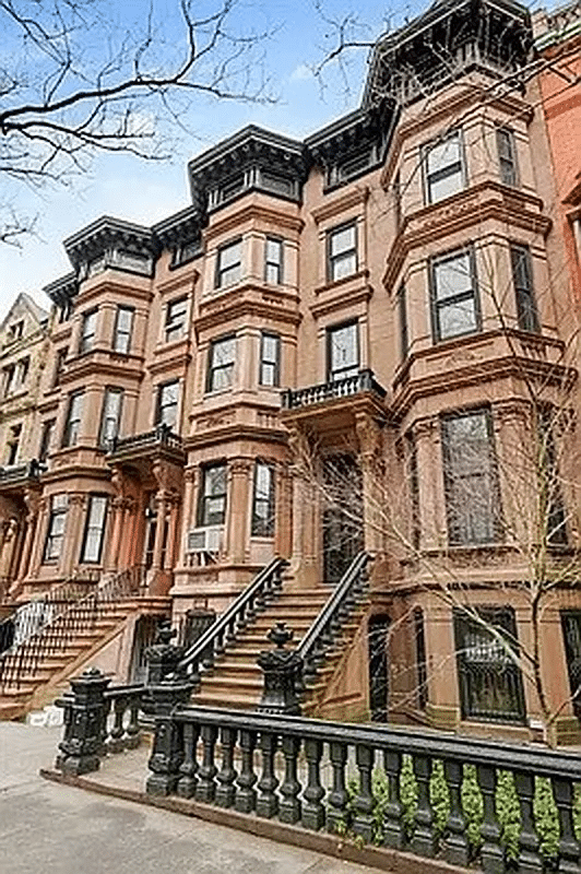 exterior of the brownstone with stoop and bracketed cornice