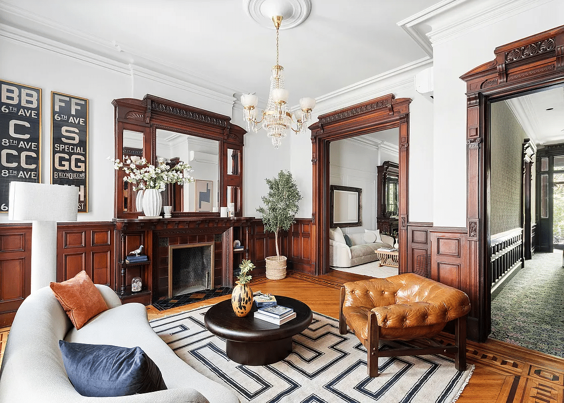 rear parlor with wainscoting, moldings, and a mantel with mirror