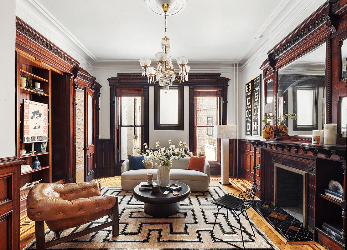 rear parlor with wainscoting, moldings, and a mantel with mirror