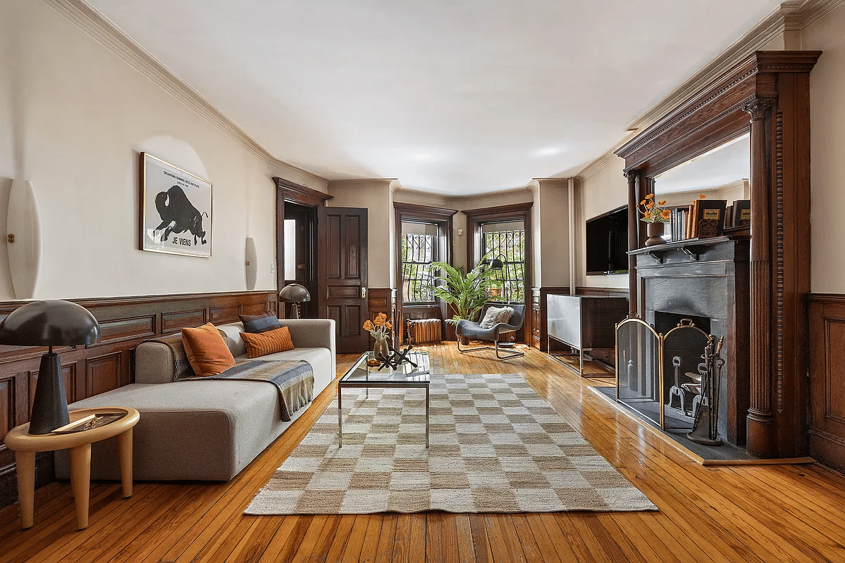 den on garden level with columned mantel, wainscoting