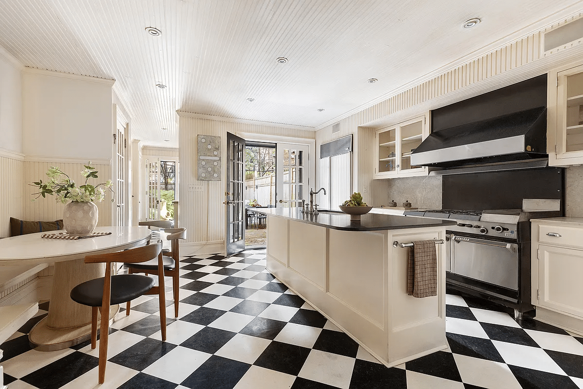 kitchen with beadboard ceiling and wainscoting and a checkerboard floor