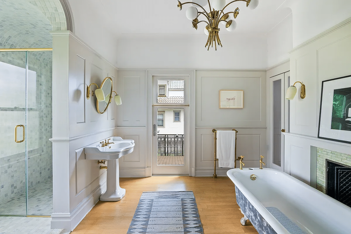 bathroom with built-in shower, clawfoot tub, pedestal sink, door to porch