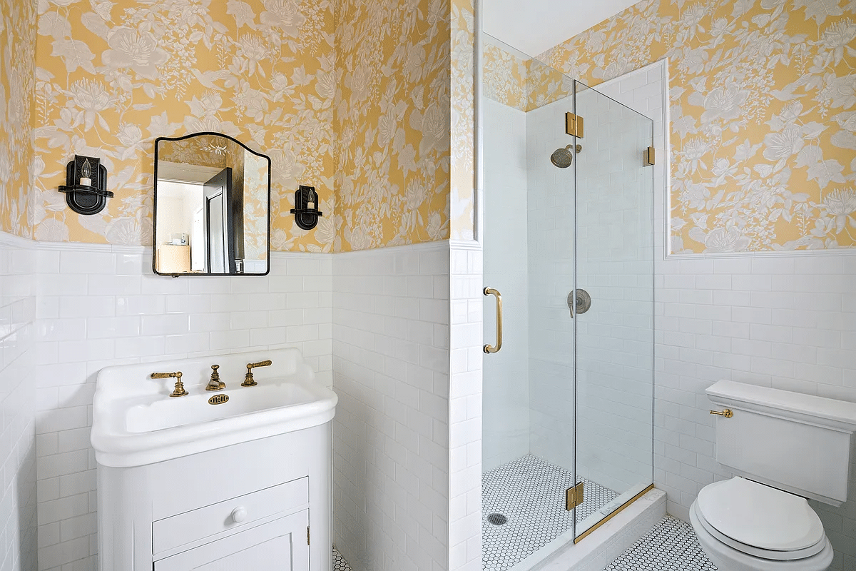 bathroom with shower, yellow floral wallpaper