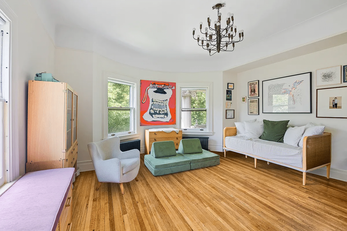 bedroom with wood floor, curved bay