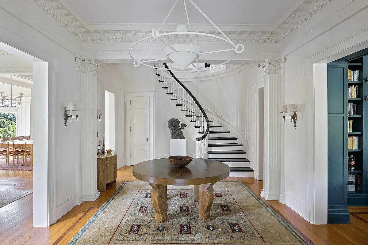 foyer with pilasters, curved staircase