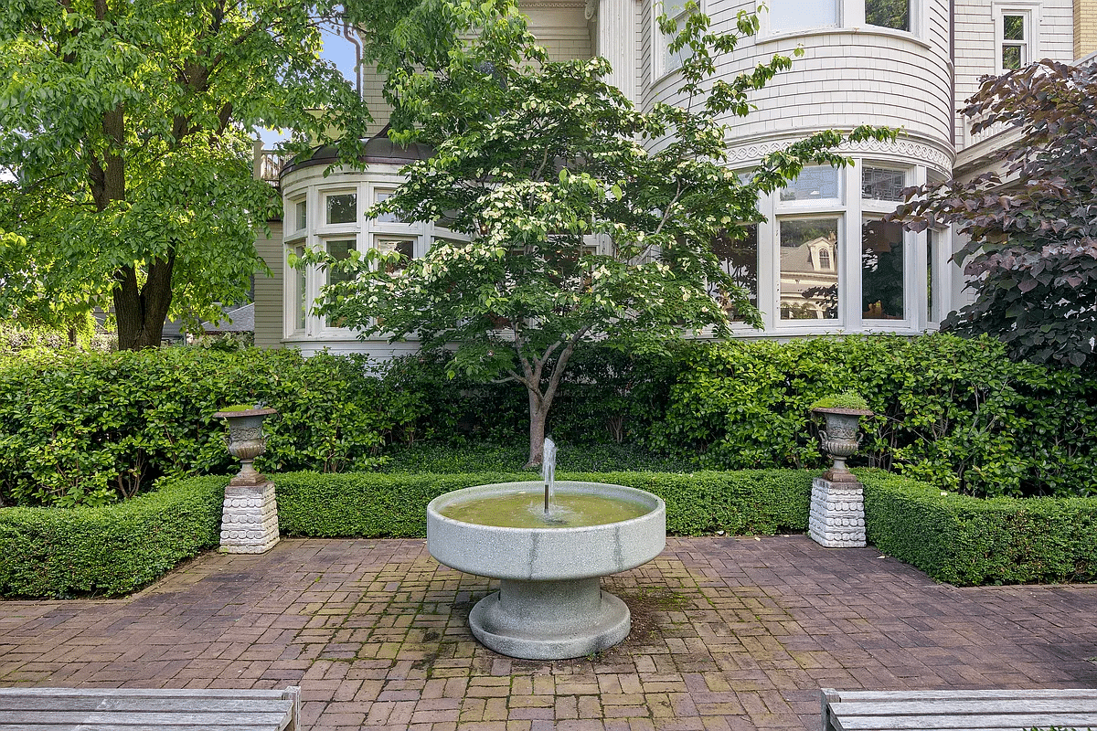 rear yard with brick paved patio with fountain