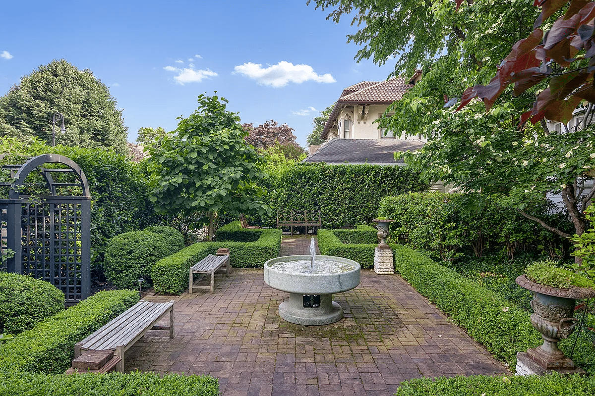 rear yard with brick paved patio with fountain