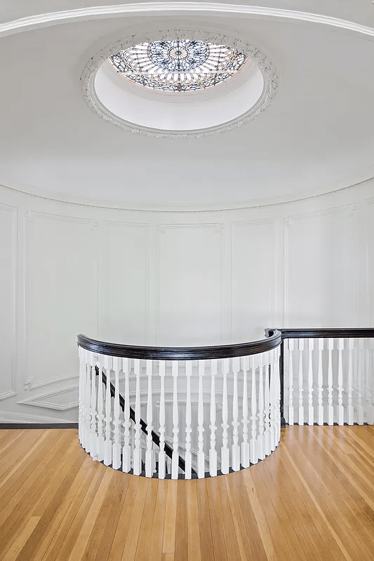 upstairs landing with view of stained glass, circular skylight