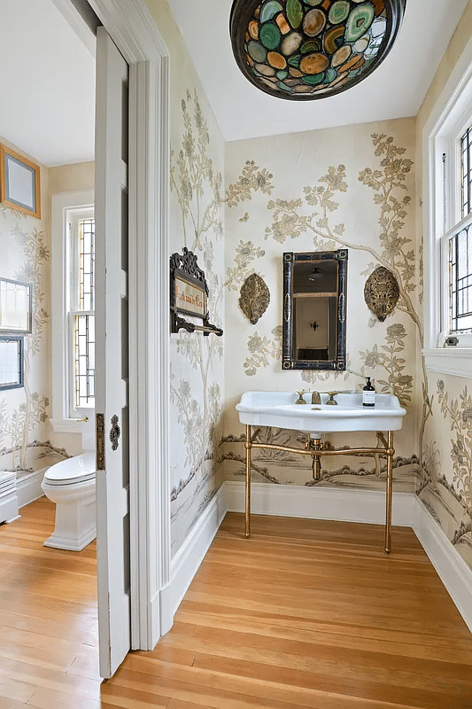 powder room with console sink and a landscape wallpaper