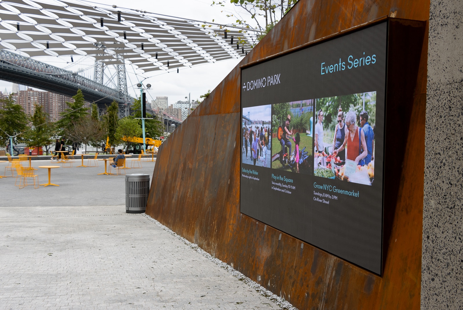 a screen at the entrance showing upcoming events