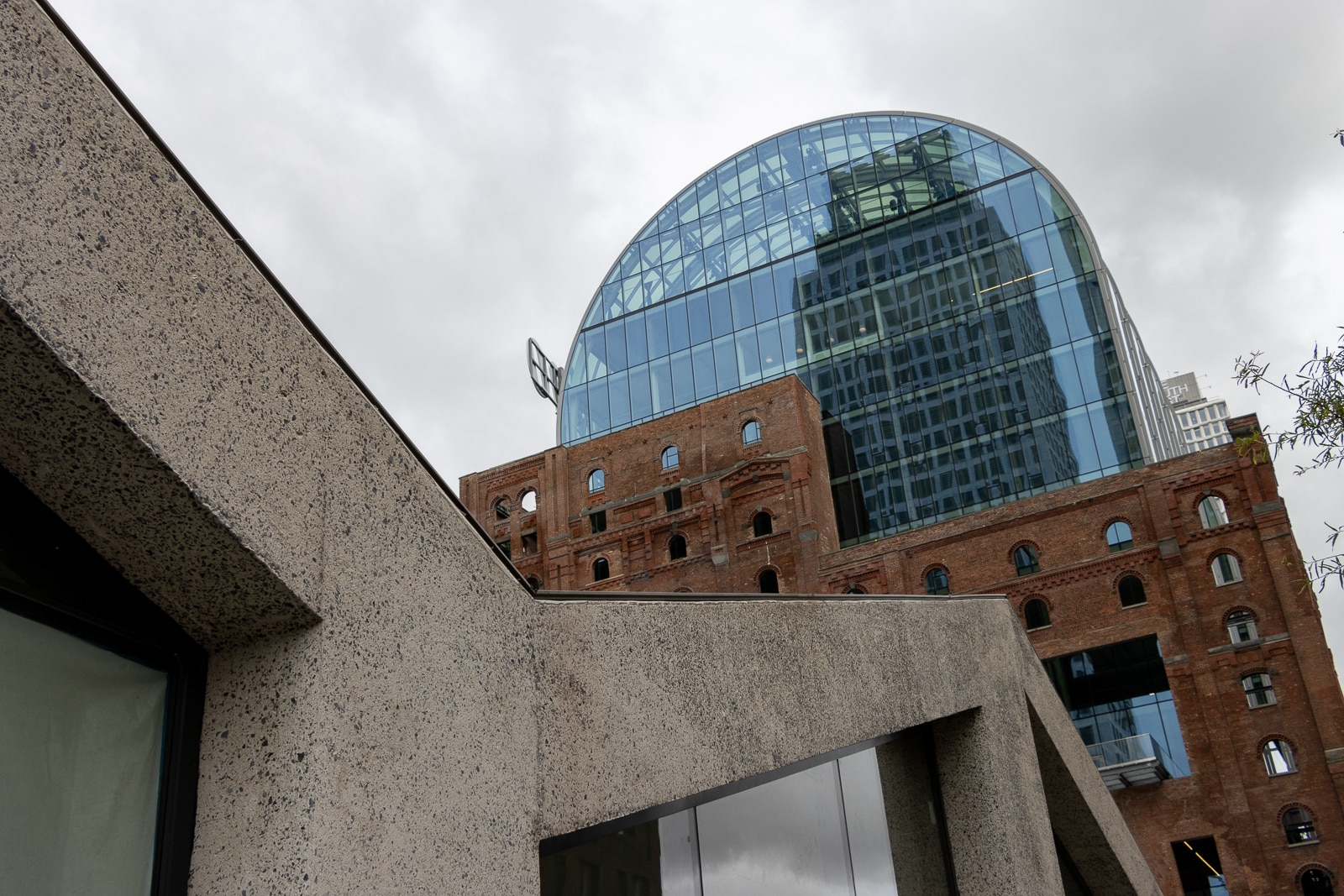 the angles of the new building and the glass dome of the refinery