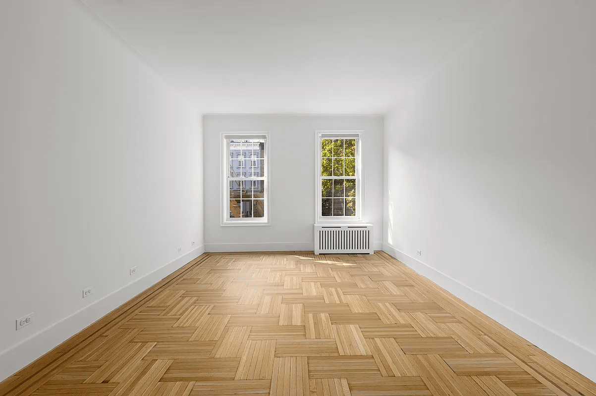 bedroom with two windows, wood floor