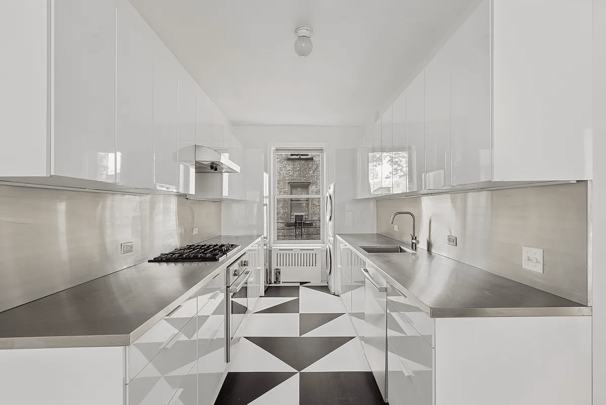 kitchen with black and white floor tile, white cabinets