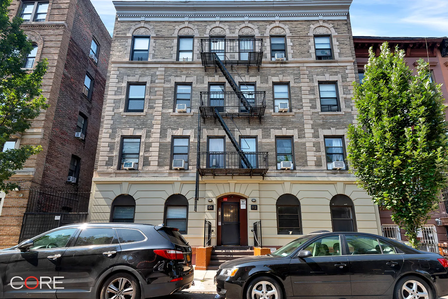 exterior of the brick building with classical details including keystoned lintels