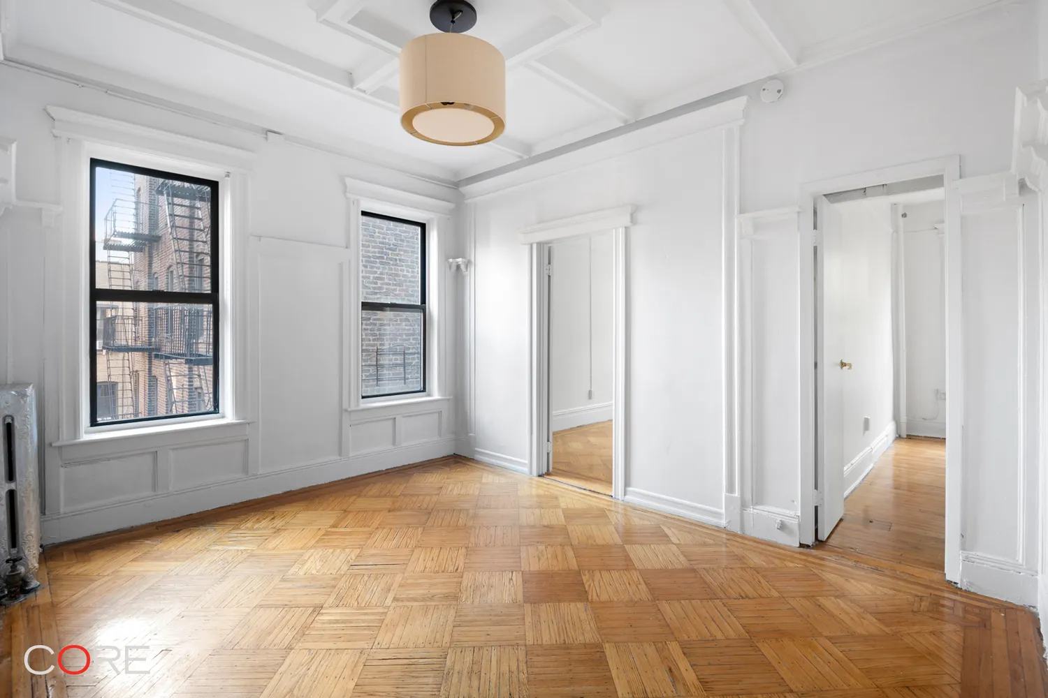 clinton hill - living room with two windows, beamed ceiling and white walls and trim