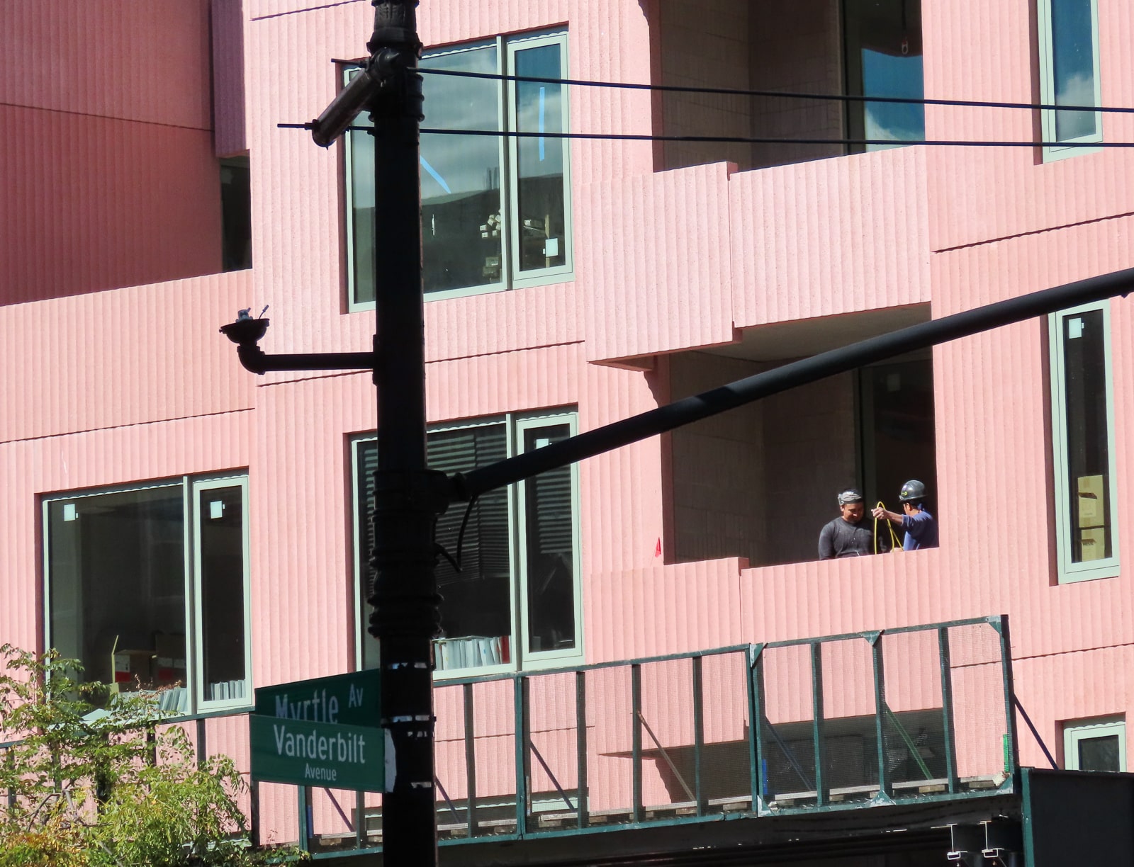 construction workers inside the pink building