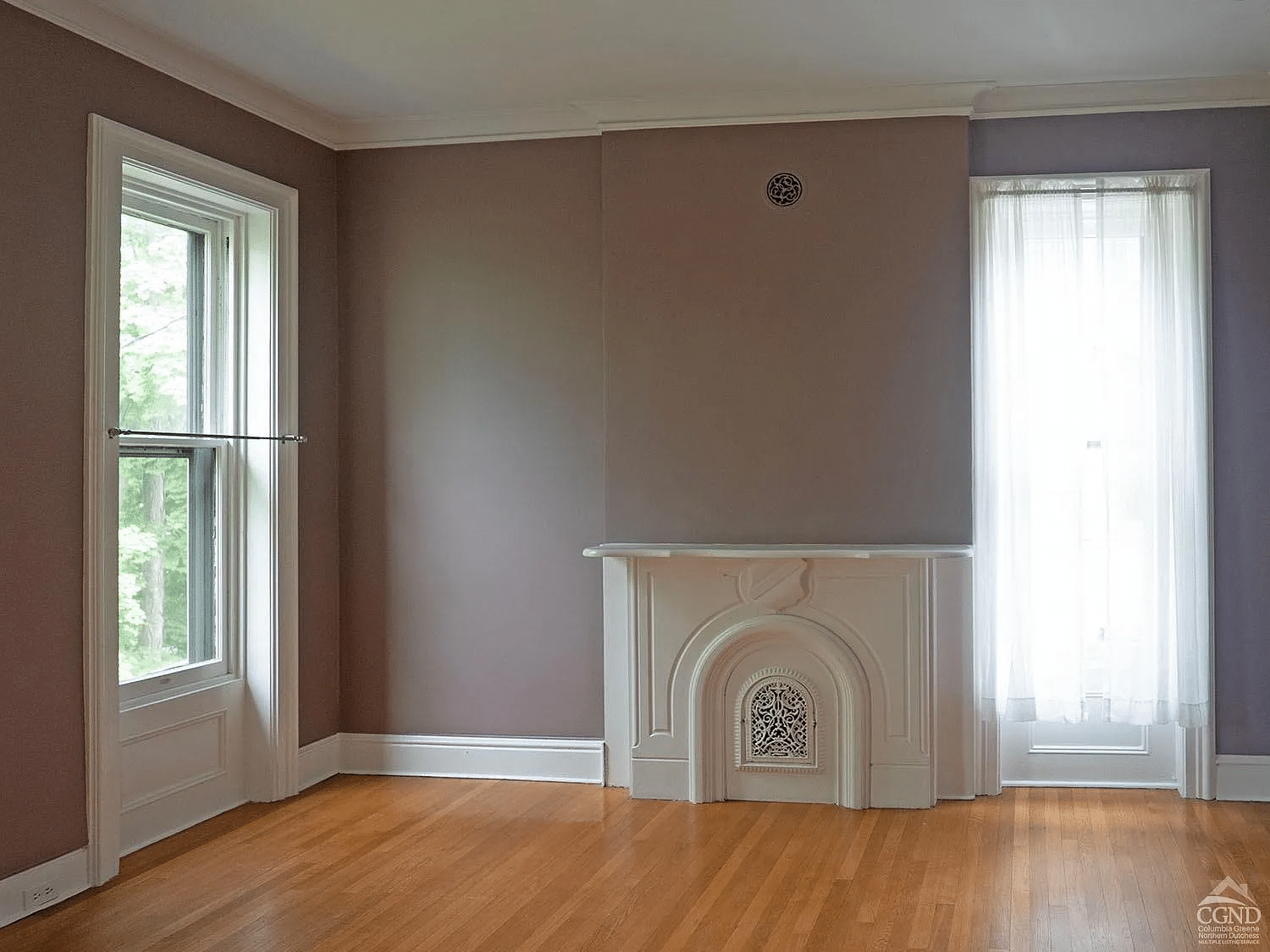 bedroom with purple walls and a white painted mantel