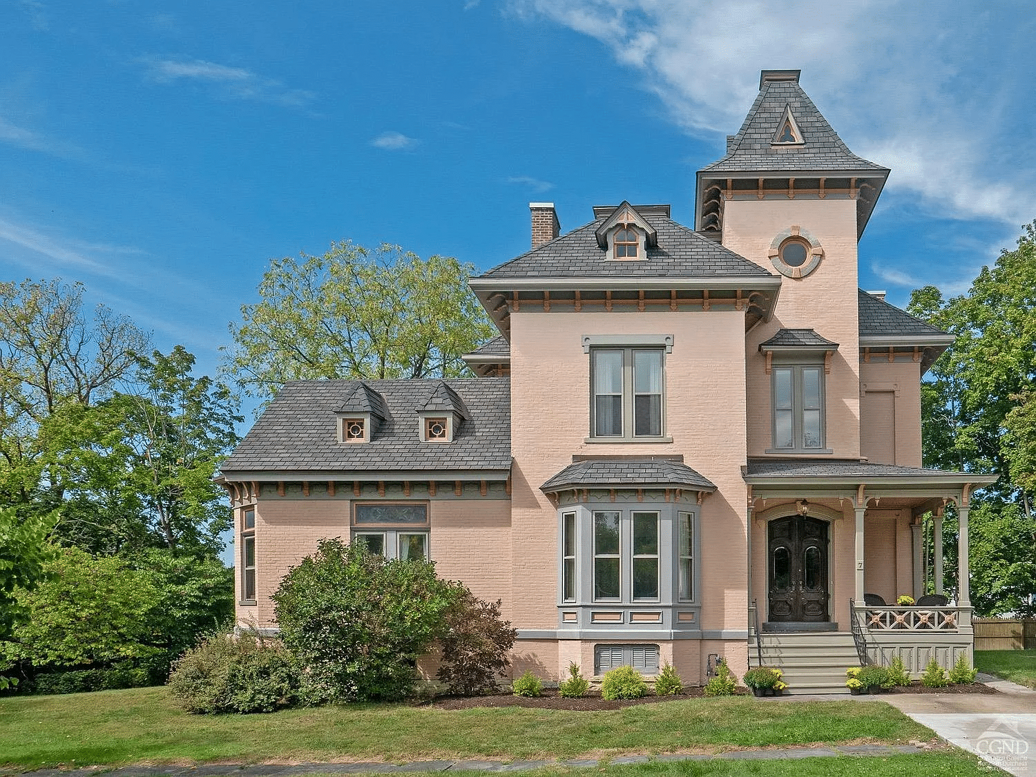 hudson - a second empire manse with a tower painted a pale pink