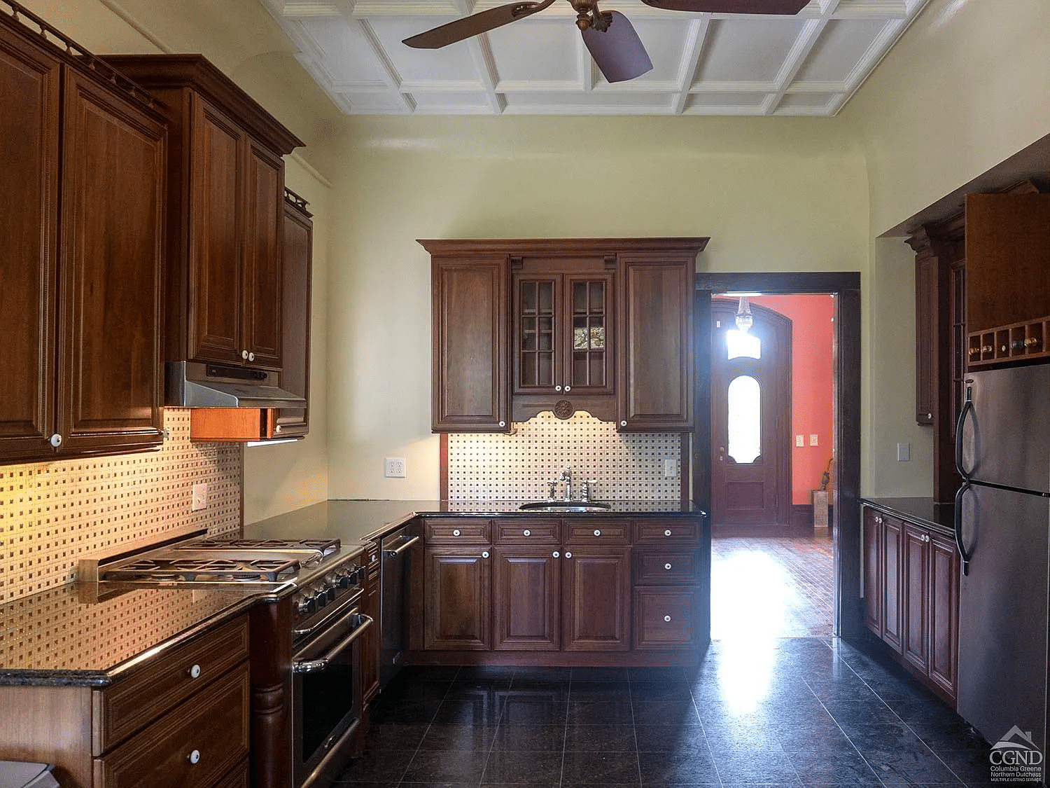 kitchen with wood cabinets, black tile floor