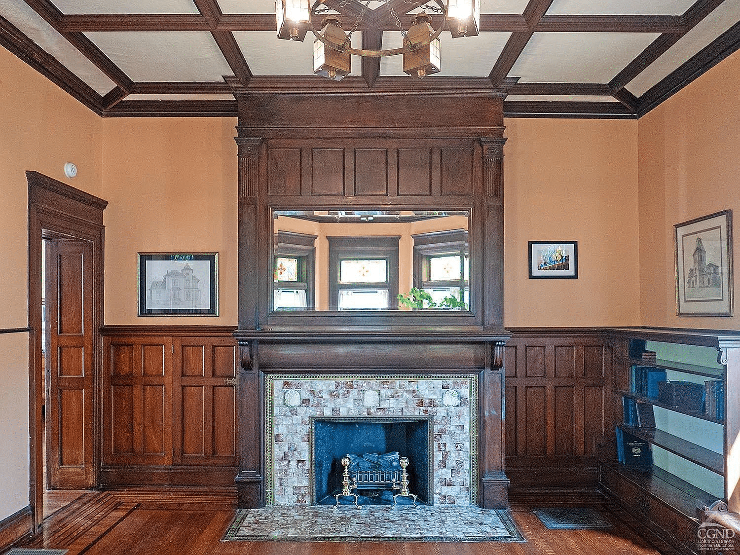 library with beamed ceiling, wainscoting mantel with mirror