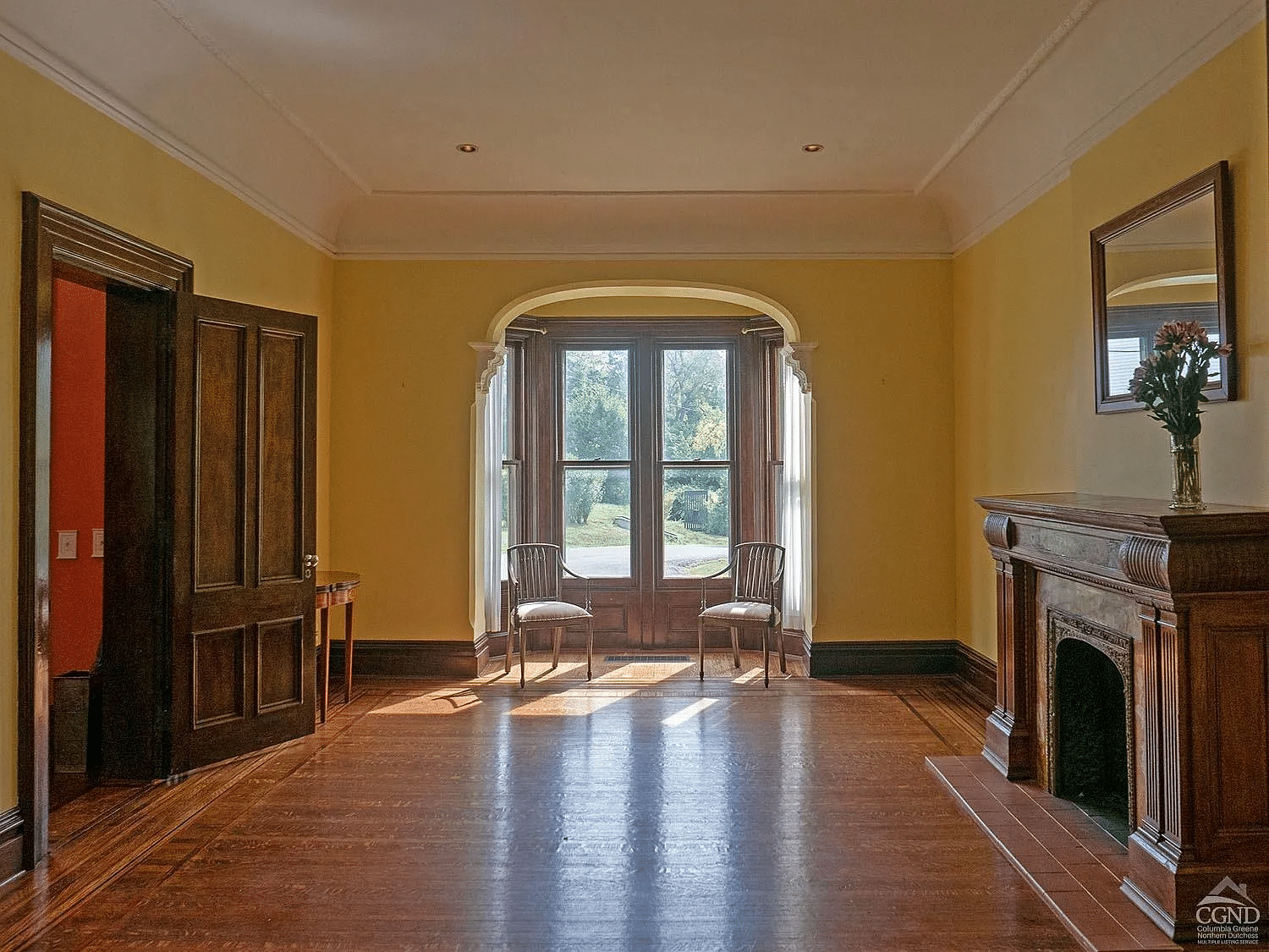 parlor with bay window niche, wood mantel