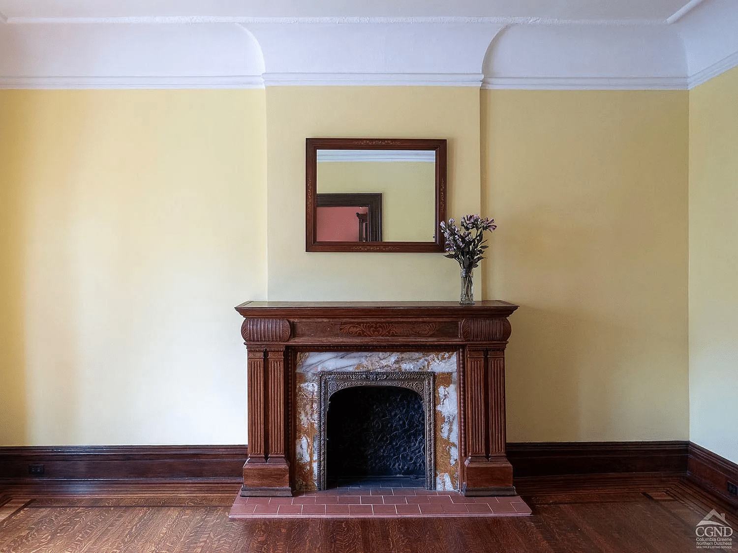 parlor with wood mantel, picture rail