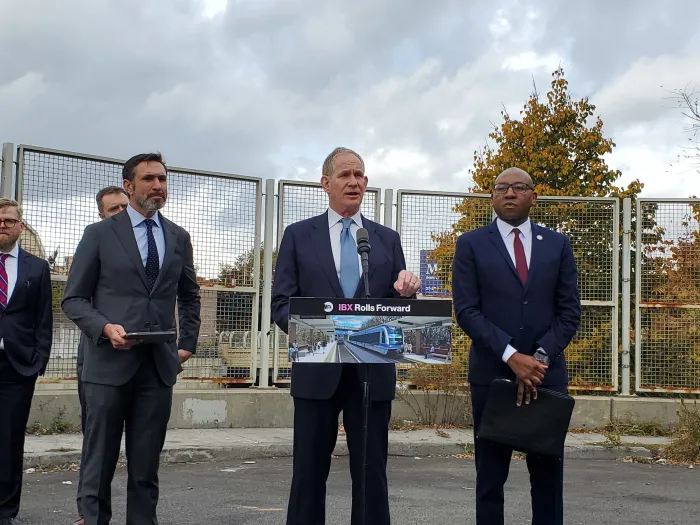 MTA Chief Janno Lieber speaks in Jackson Heights with MTA construction chief Jamie Torres-Springer (left) and Queens Borough President Donovan Richards.
