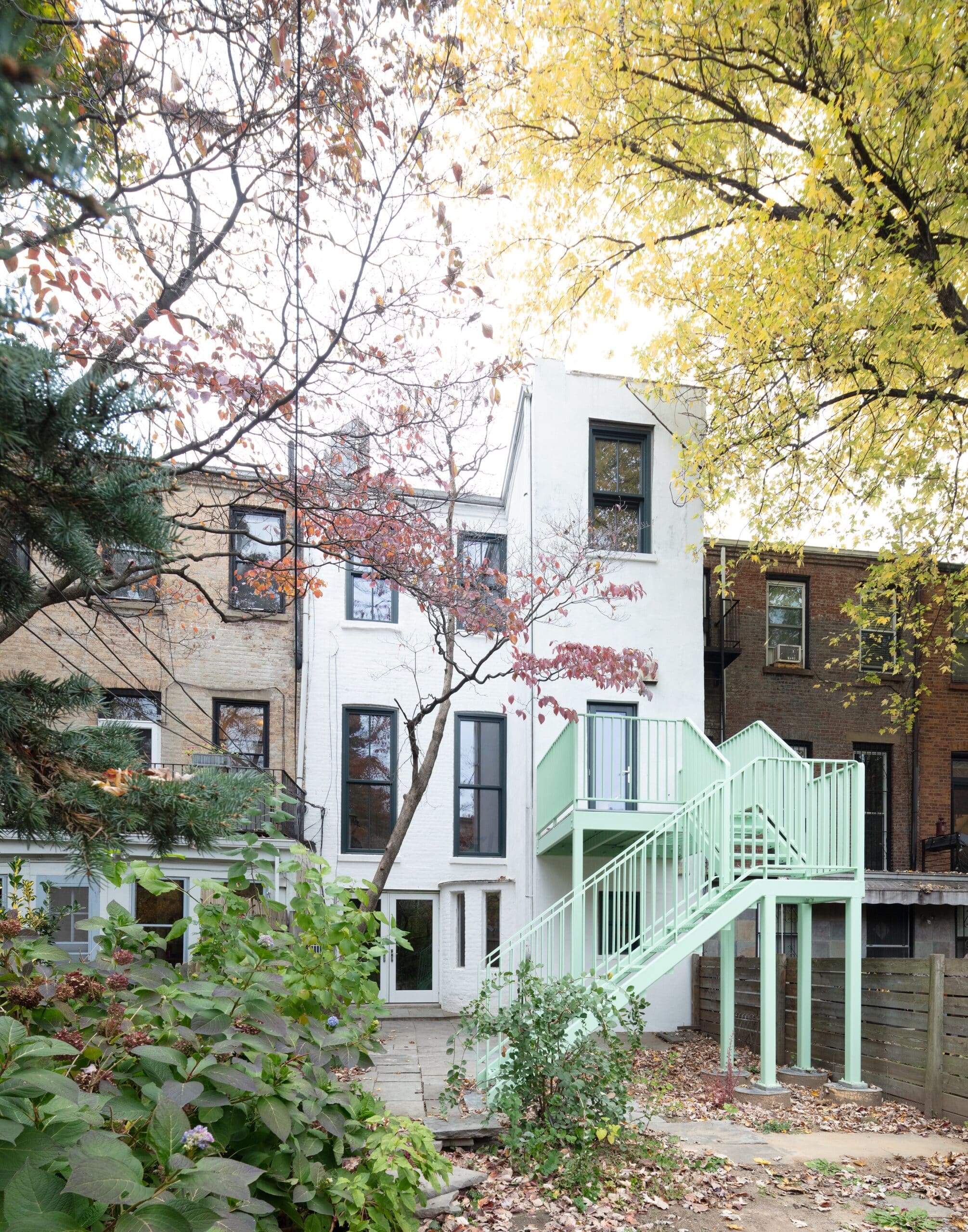 REAR FACADE WITH PALE GREEN STAIRCASE TO THE GARDEN