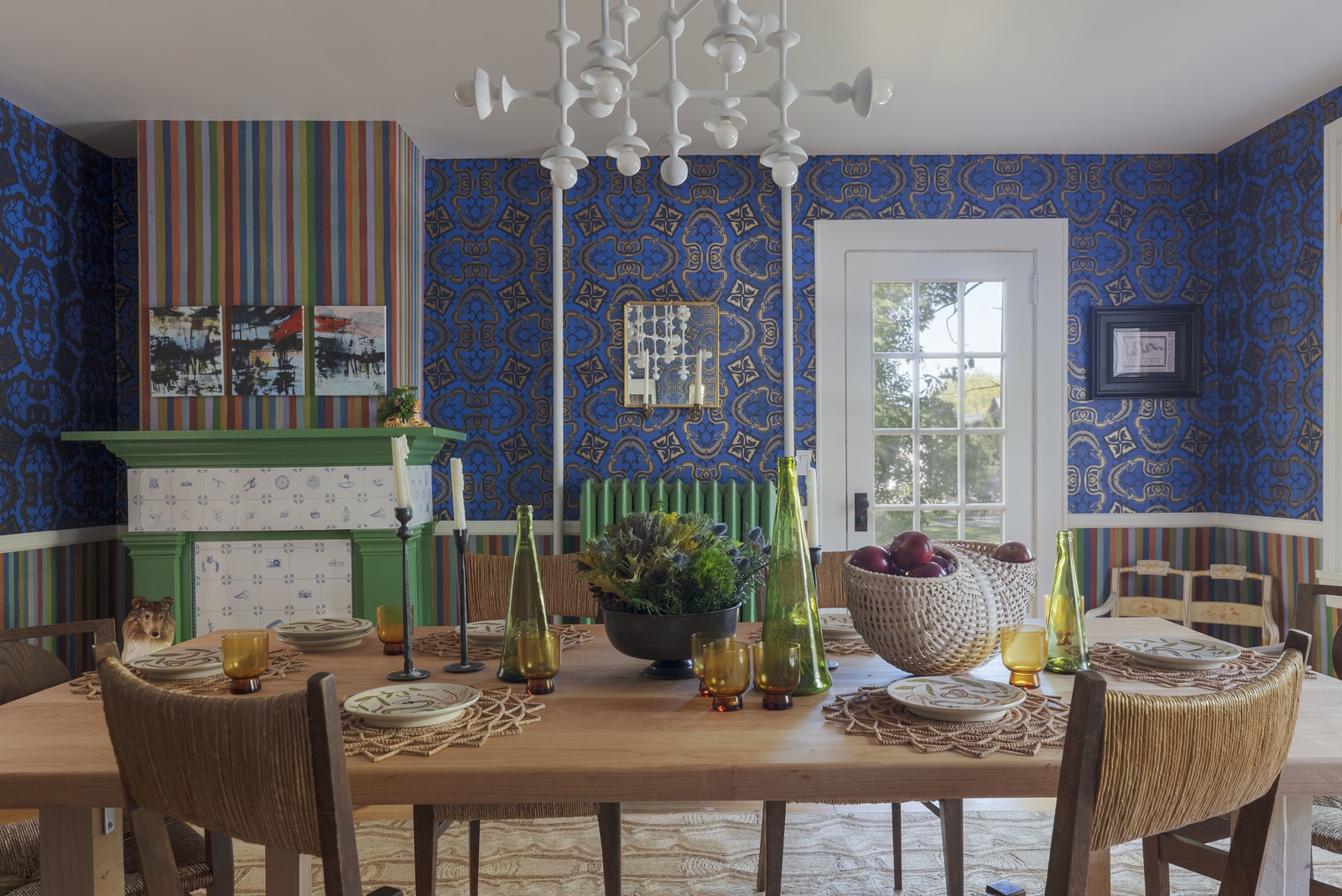 dining room with blue wallpaper and a bright green mantel