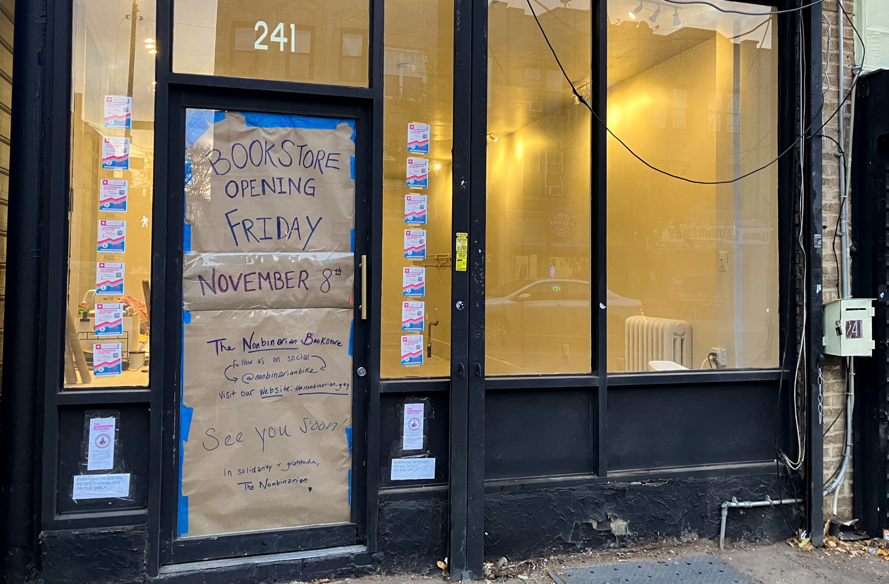 the door to the new bookstore with signage announcing a november 8 opening