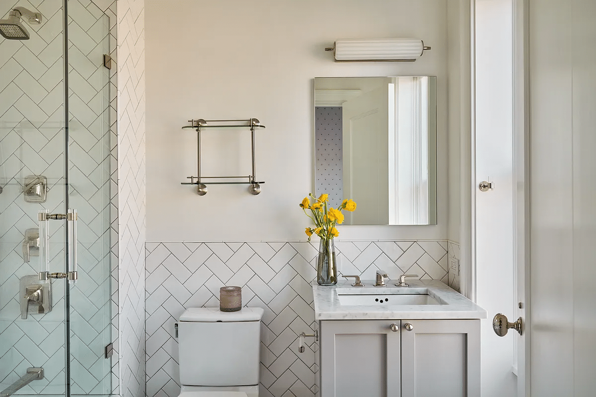 bathroom with glass-doored shower, white tile