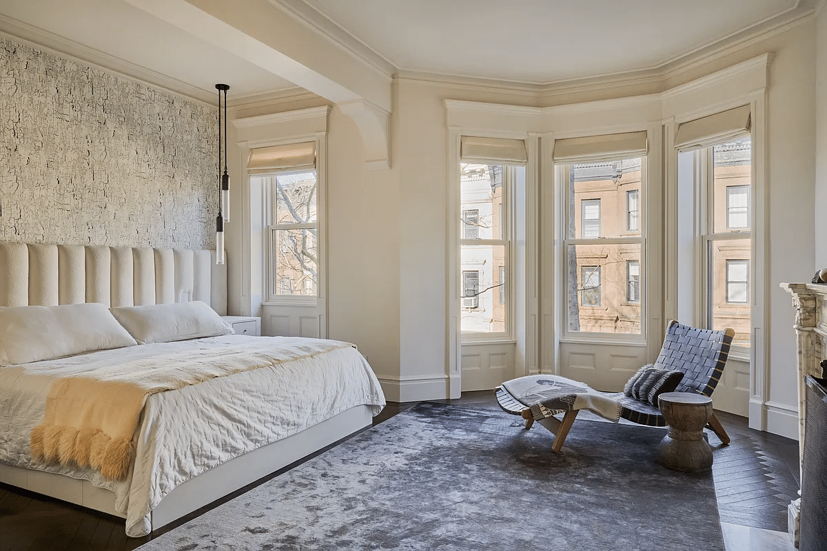 bedroom with bed niche and a mantel