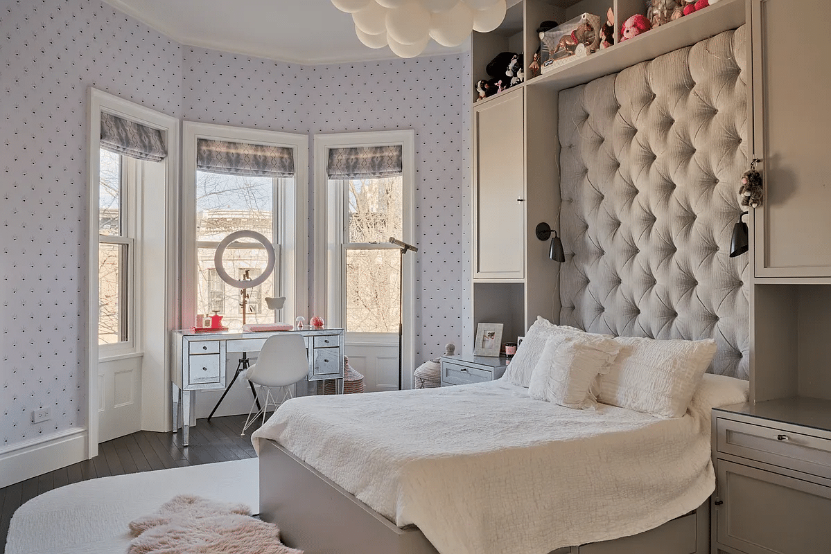 bedroom with wallpaper, built-in storage