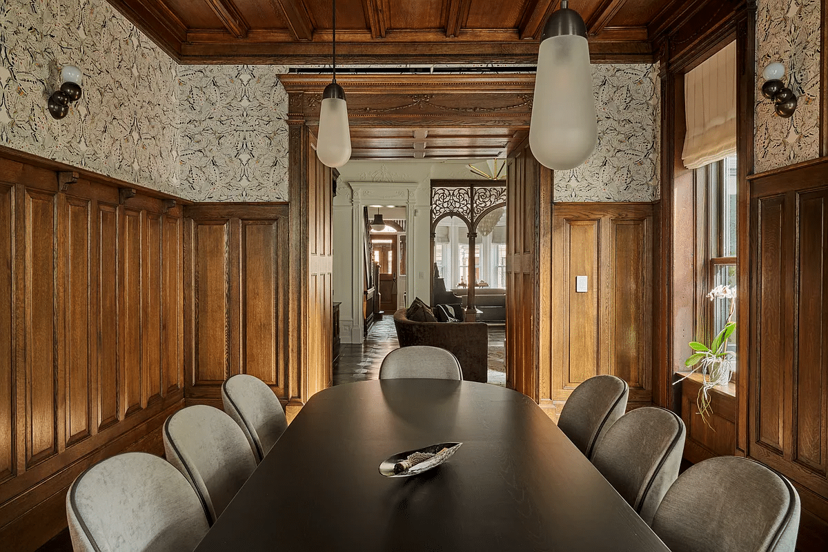 dining room with wainscoting, moldings and coffered ceiling