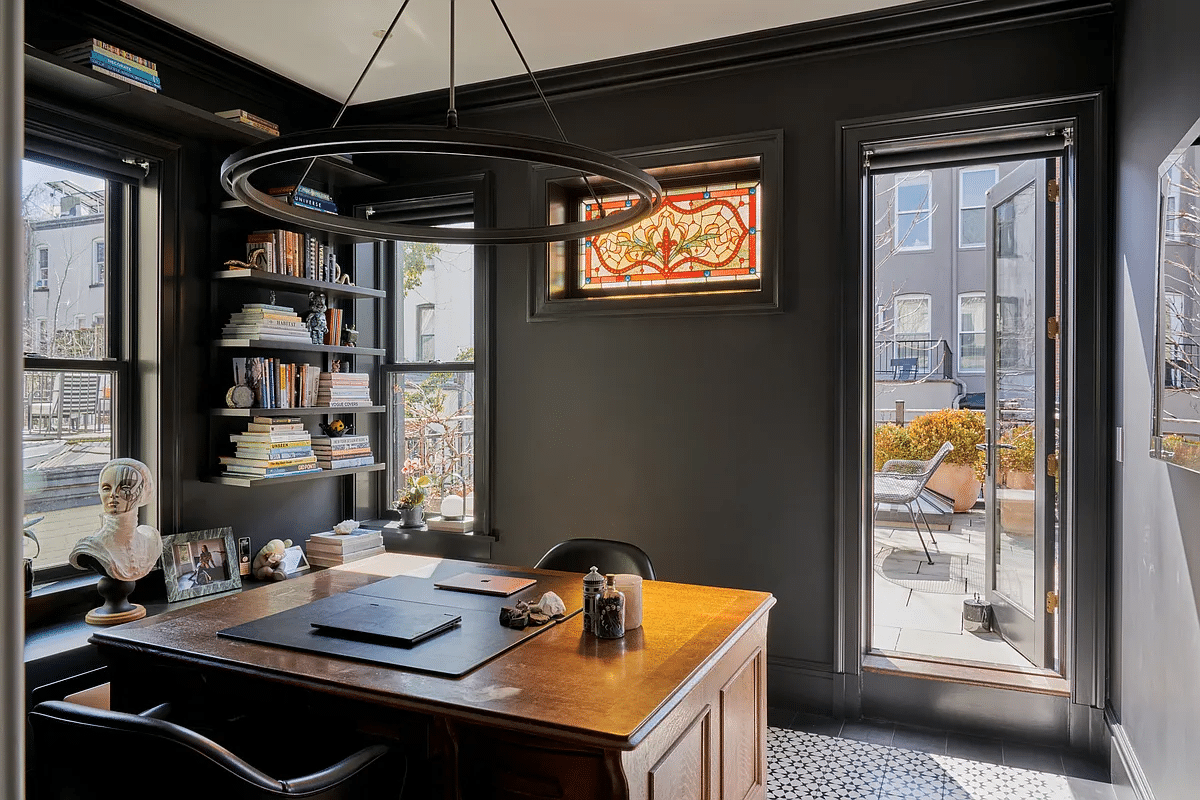 study with stained glass window and a glass door to a terrace