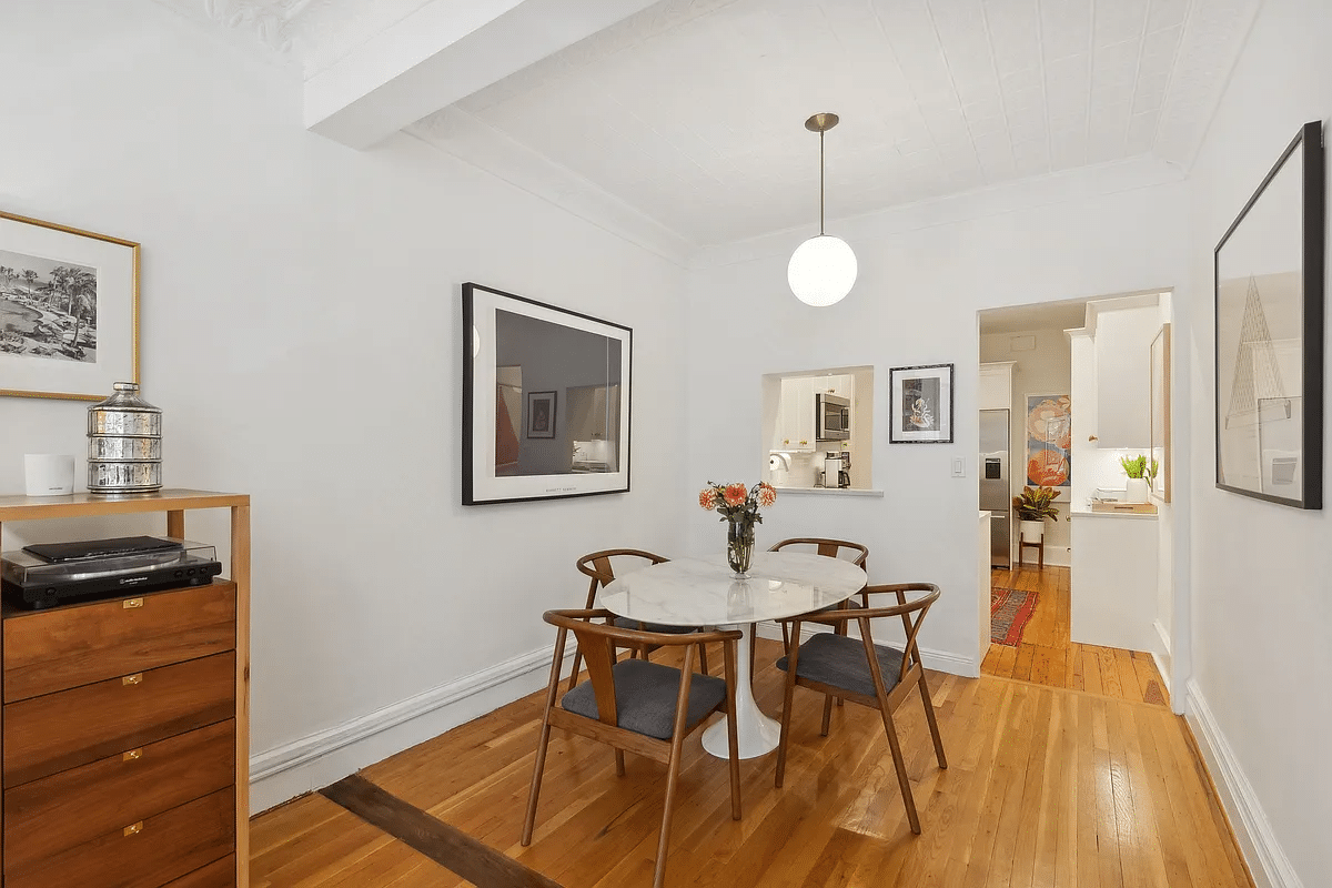 dining area with passthrough and doorway to kitchen